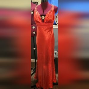 Peach gown with rhinestone accents on the shoulders and back